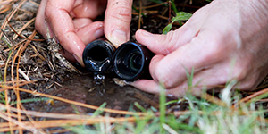 hands holding an irrigation pipe